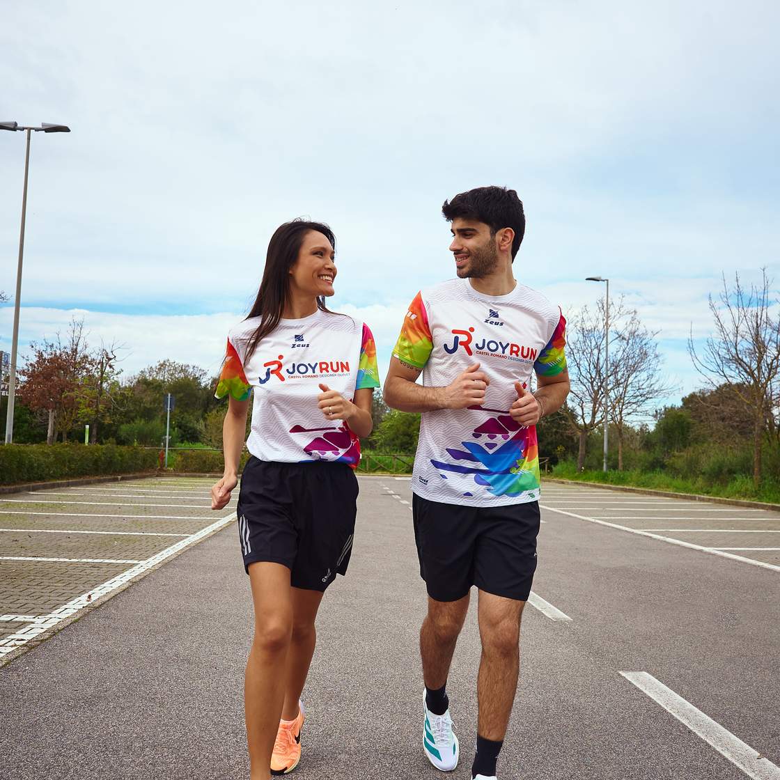 a boy and  a girl are runnning in a street