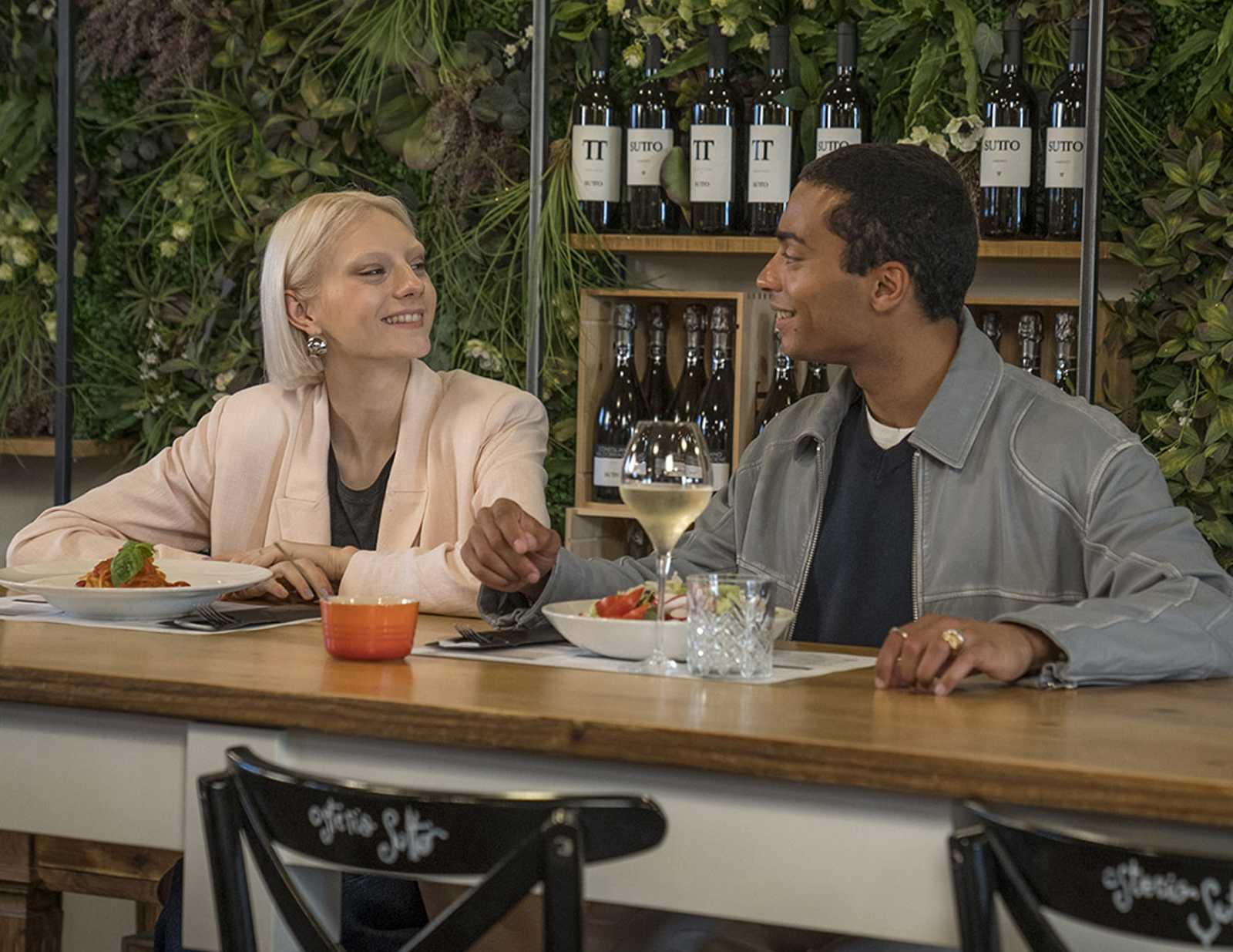 A couple sharing a pasta meal at a restaurant located at Noventa di Piave Designer Outlet.
