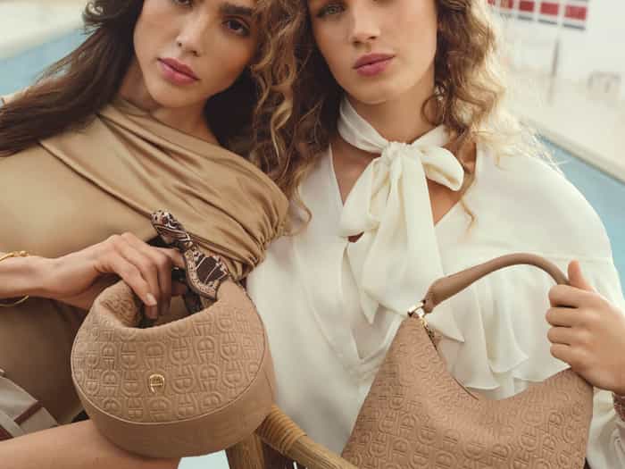 Two girls with a brown leather bag