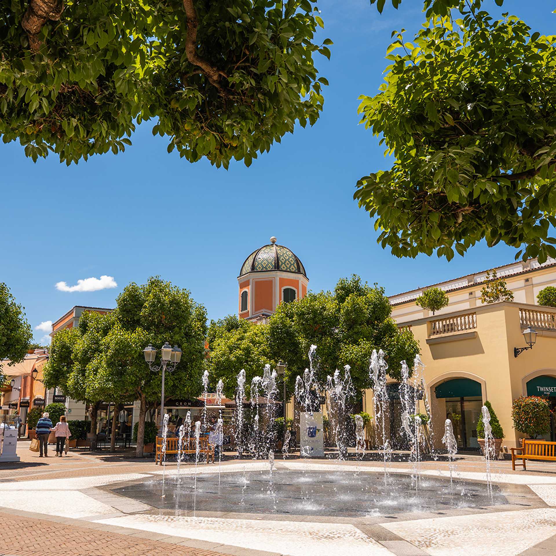 Fountain in La Reggia Designer Outlet in a sunny day