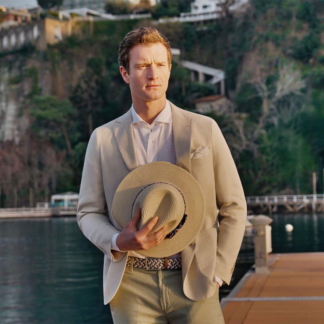 Spada man in a suit holding a hat